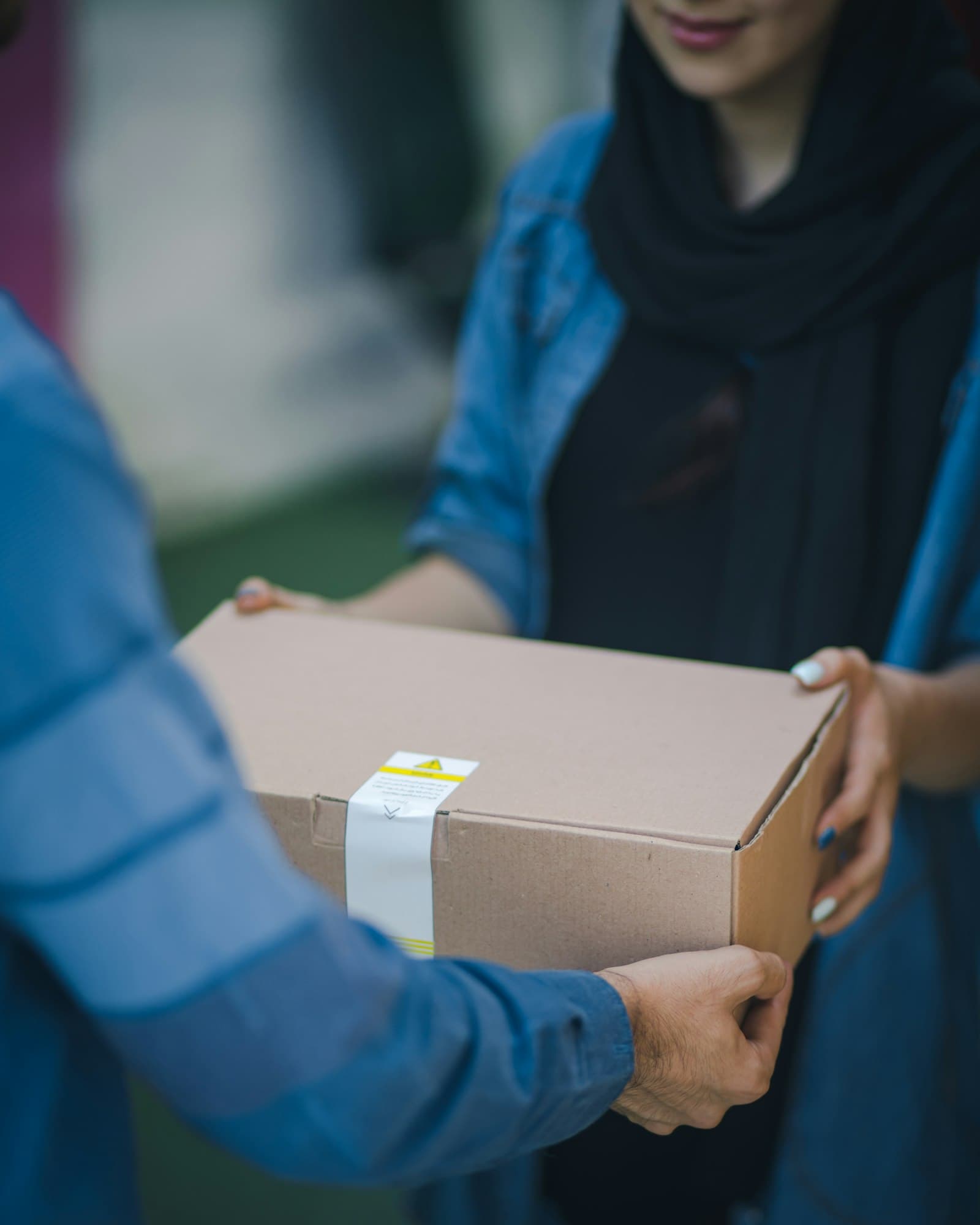 Person handing over a shipping box